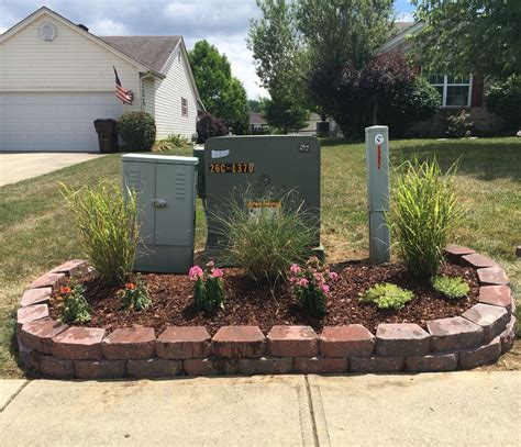 creative way to hide electrical box in yard|landscaping to hide utility box.